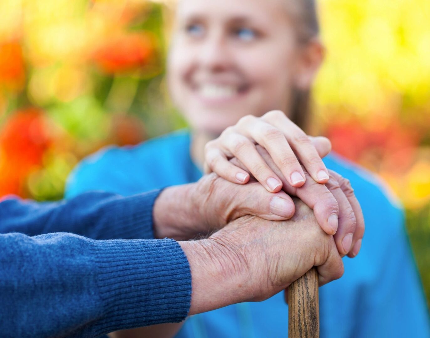 A woman holding hands with an older man.